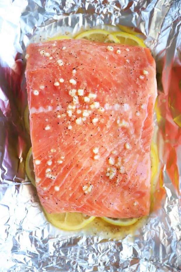 Salmon filet on lemon in foil photo
