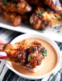 Dipping a wing in BBQ blue cheese sauce