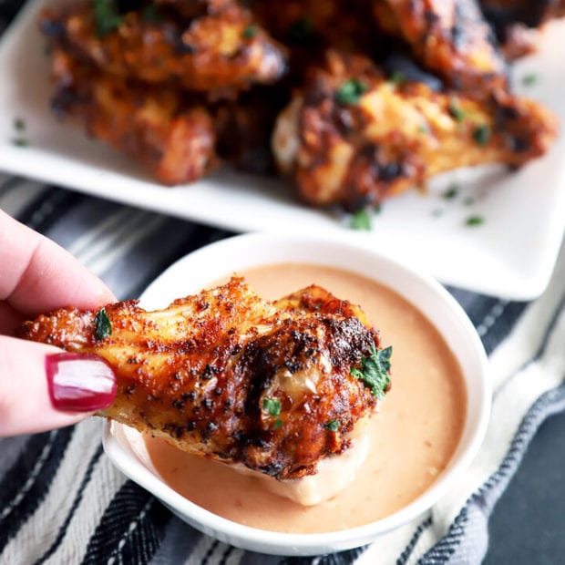 Dipping a wing in BBQ blue cheese sauce