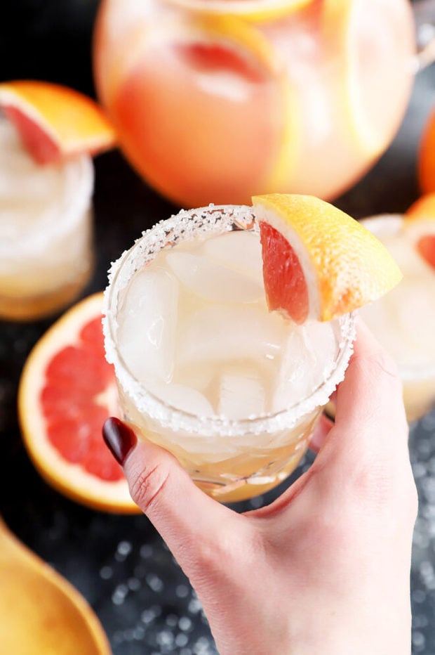 Hand holding a cocktail glass photo