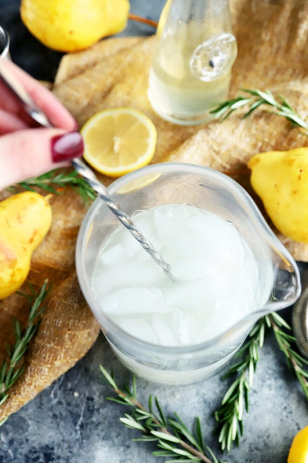 Stirring together a gin and tonic cocktail image