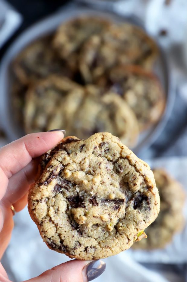 Hand holding chocolate chip cookies with sea salt