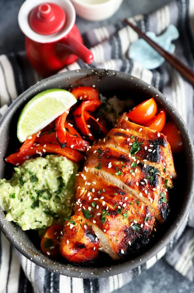 Sliced Korean spicy chicken in a rice bowl image