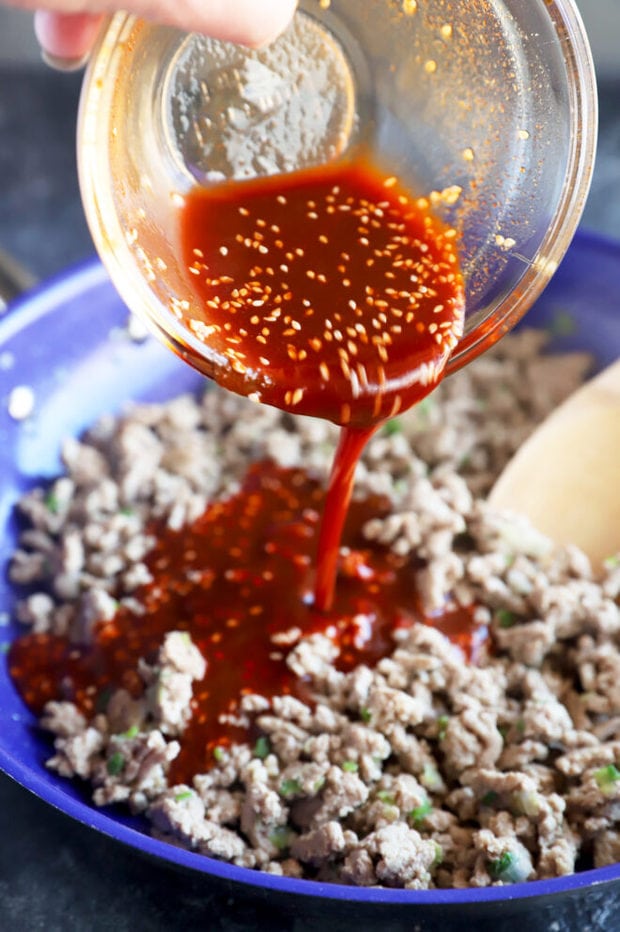 Pouring Korean sauce onto meat photo