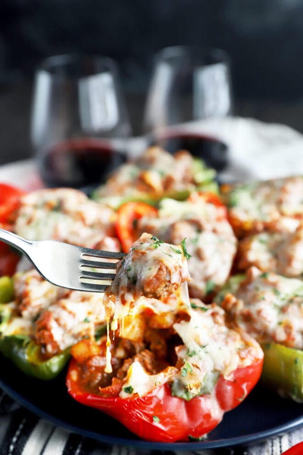 Fork of cheesy stuffed peppers on a plate image