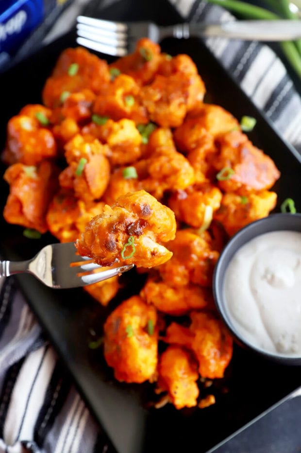 Fork holding a piece of baked cauliflower picture