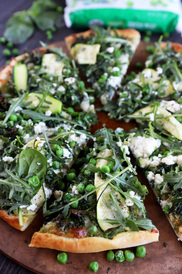 Greens pizza on a pizza stone photo