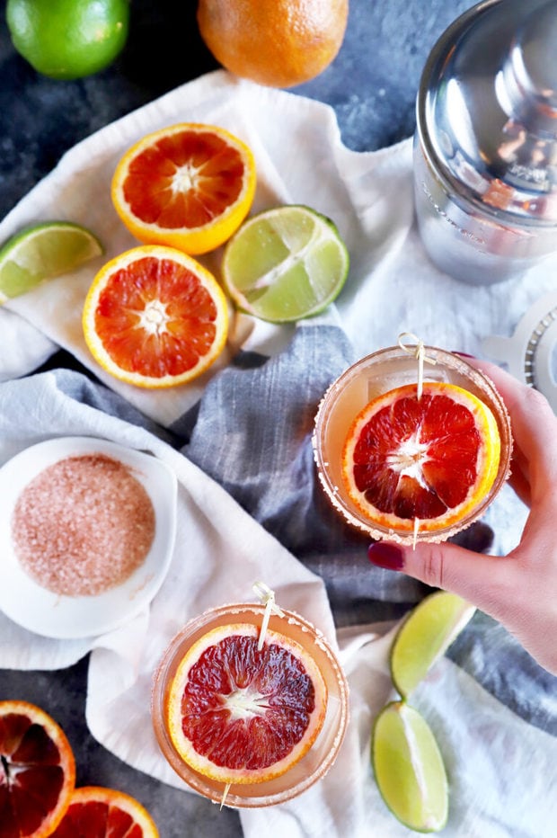 Hand holding a blood orange margarita photo