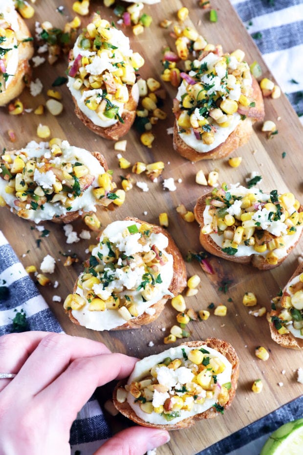 Hand holding crostini overhead photo