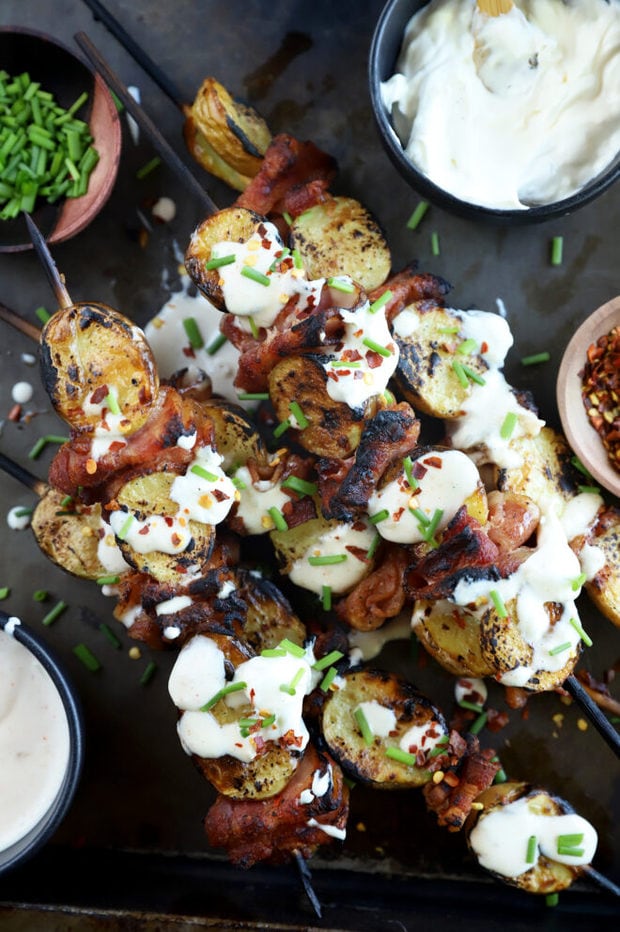 Overhead photo of loaded bacon potato skewers