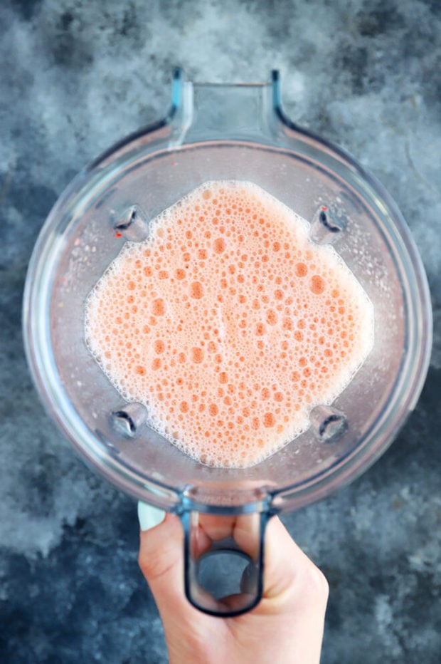 Blender with strawberries and orange photo