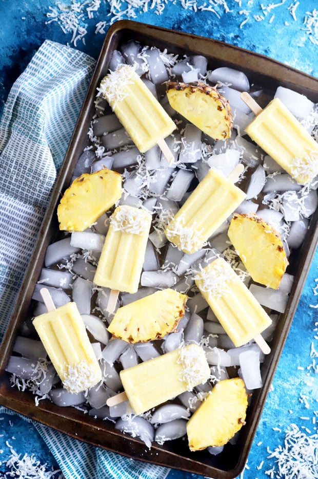 Overhead photo of popsicles on sheet pan with ice