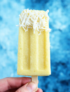 Hand holding pina colada popsicle