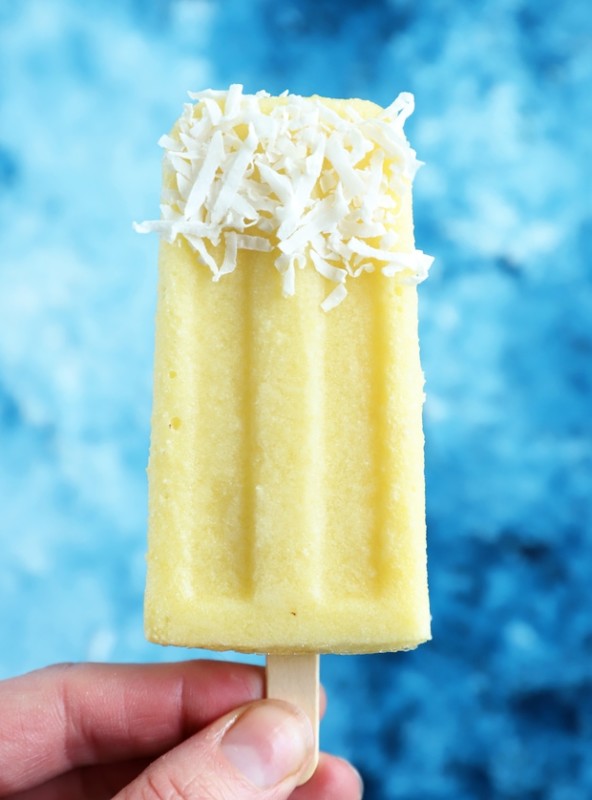 Hand holding pina colada popsicle