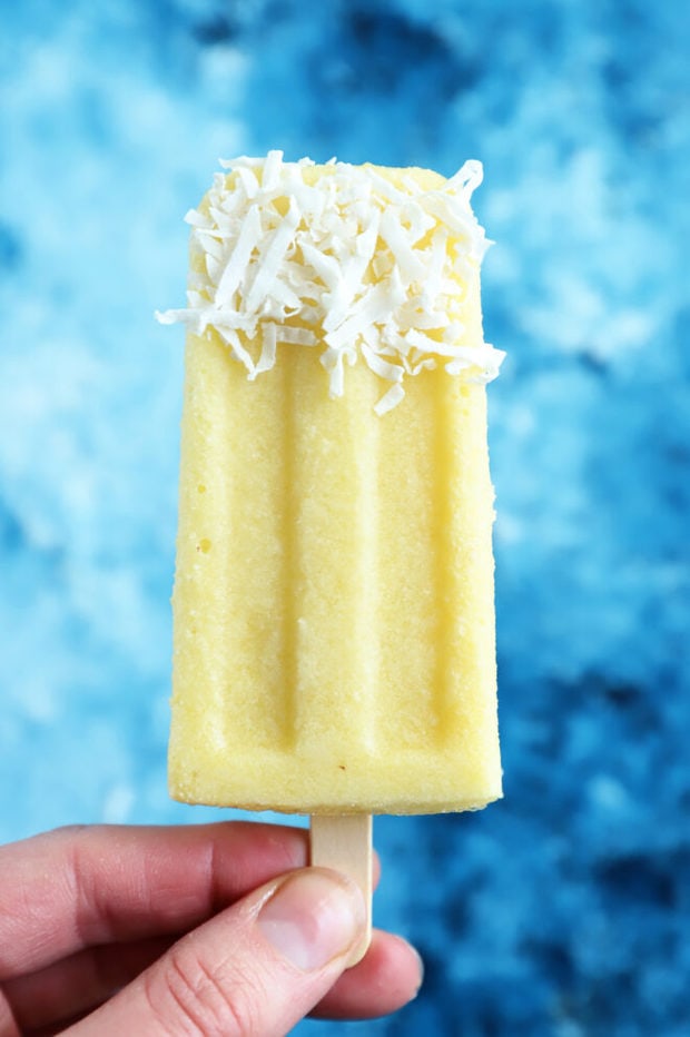 Hand holding pina colada popsicle