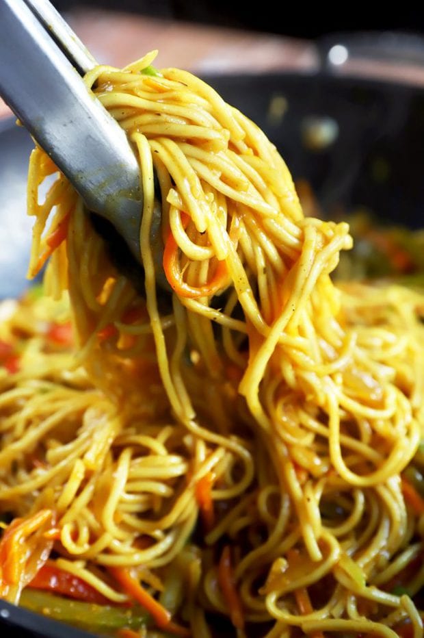 Tongs holding Asian noodles picture