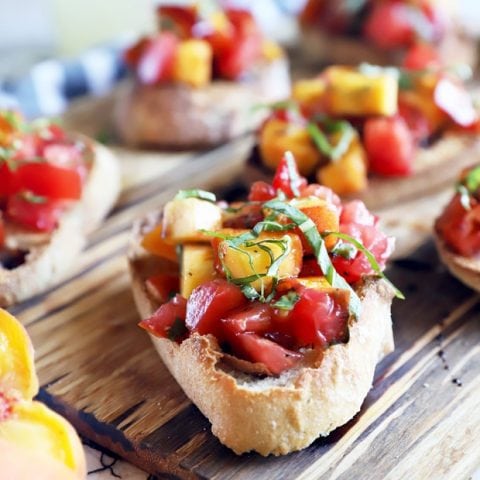 Summer tomato peach bruschetta on platter photo