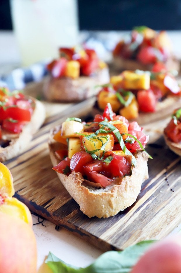 Summer tomato peach bruschetta on platter photo