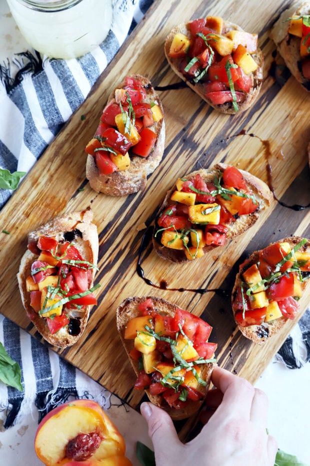 Hand holding bruschetta overhead photo 