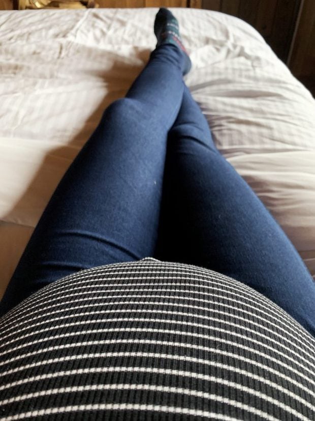 6 month pregnant belly photo on bed