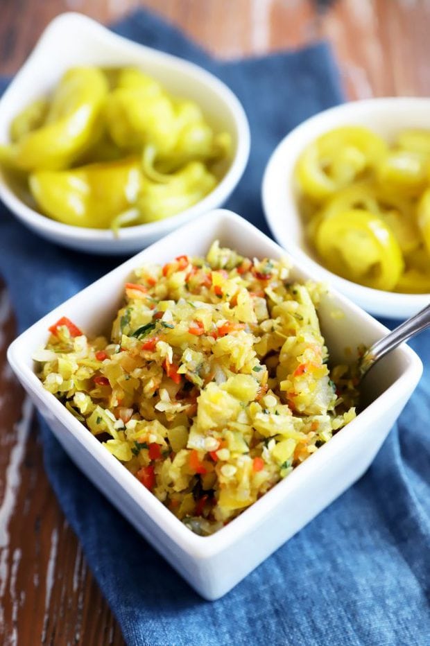 Side image of pepperoncini and jalapeño in bowl