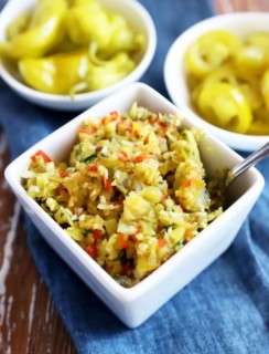 Side image of pepperoncini and jalapeño in bowl