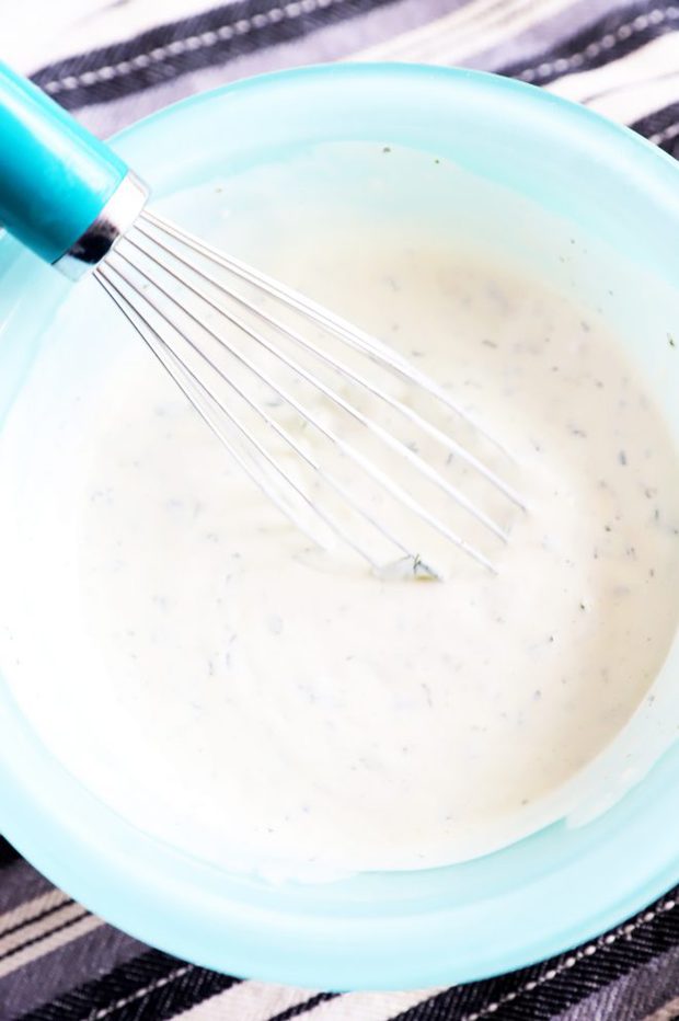 Creamy cilantro dipping sauce in a bowl with whisk image