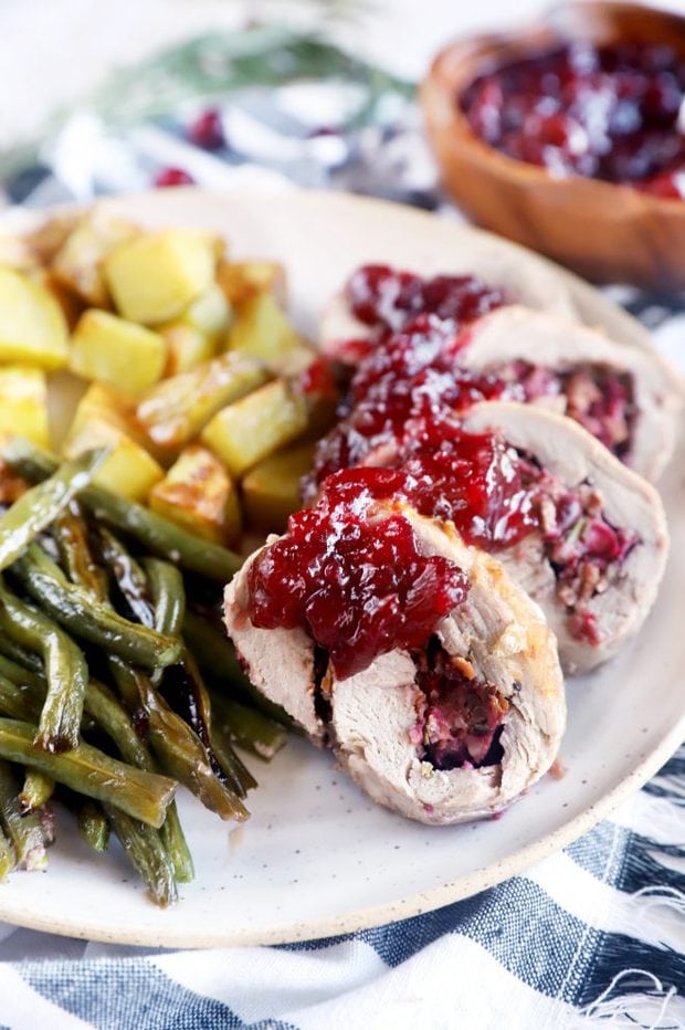 Side photo of slices of stuffed pork on a plate