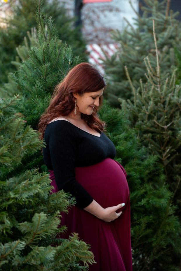 Maternity photo with christmas trees