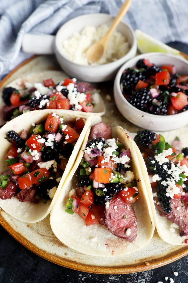 Side photo of steak tacos and blackberry salsa