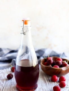 Cherries and syrup in a jar image