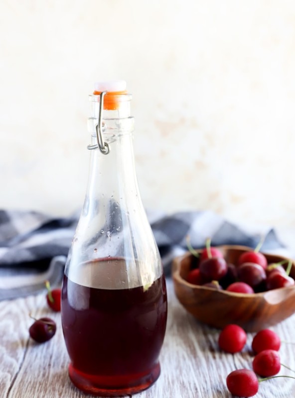 Cherries and syrup in a jar image