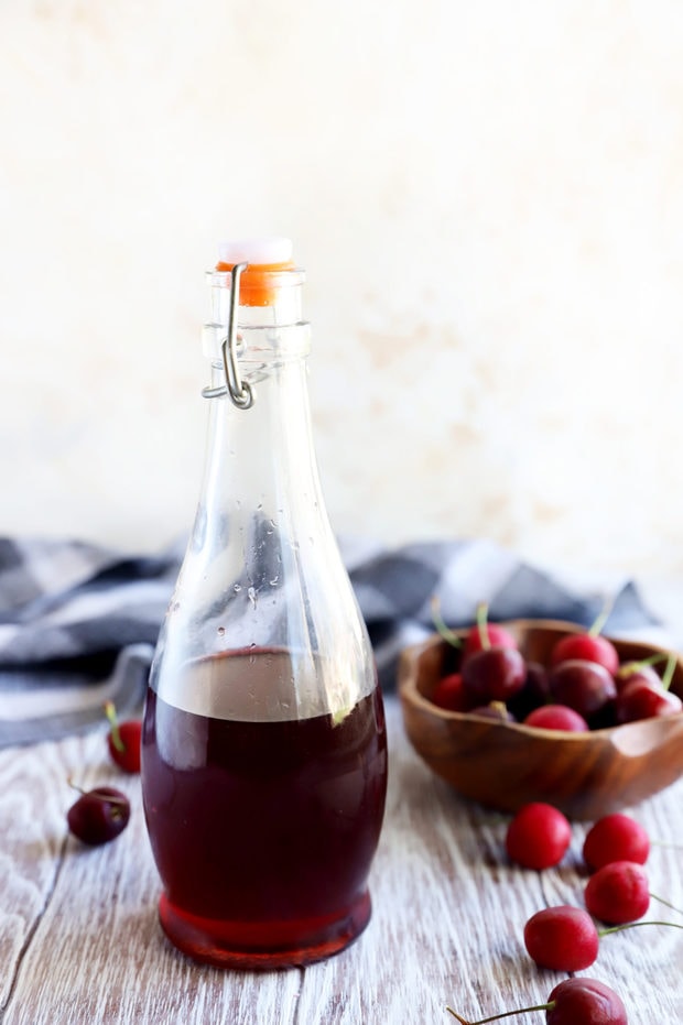 Cherries and syrup in a jar image