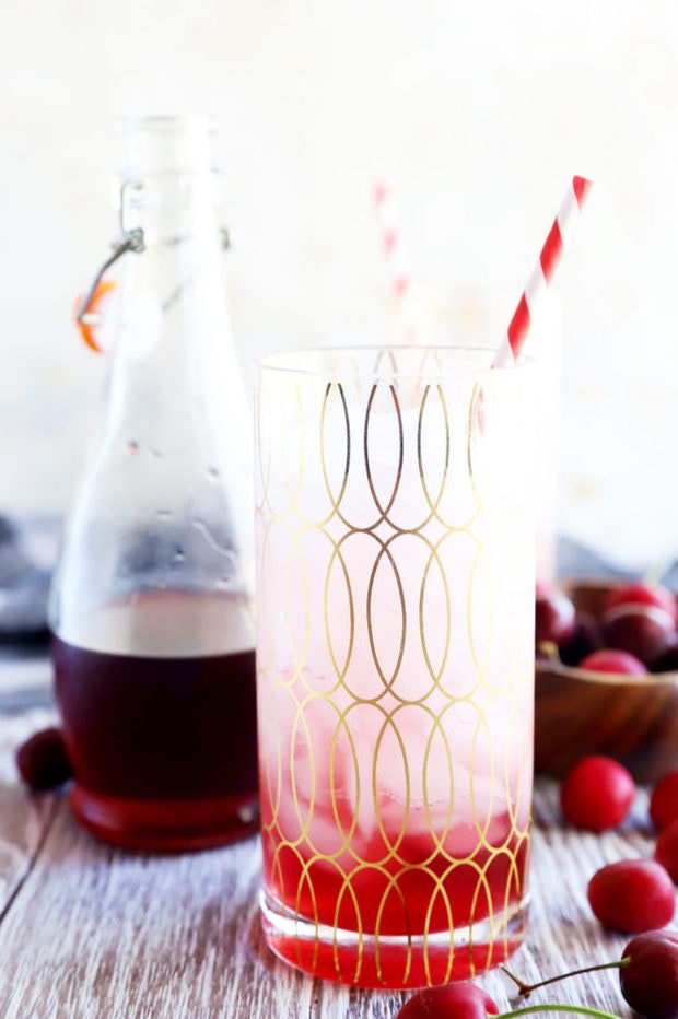 Cherry soda in a glass with straw image