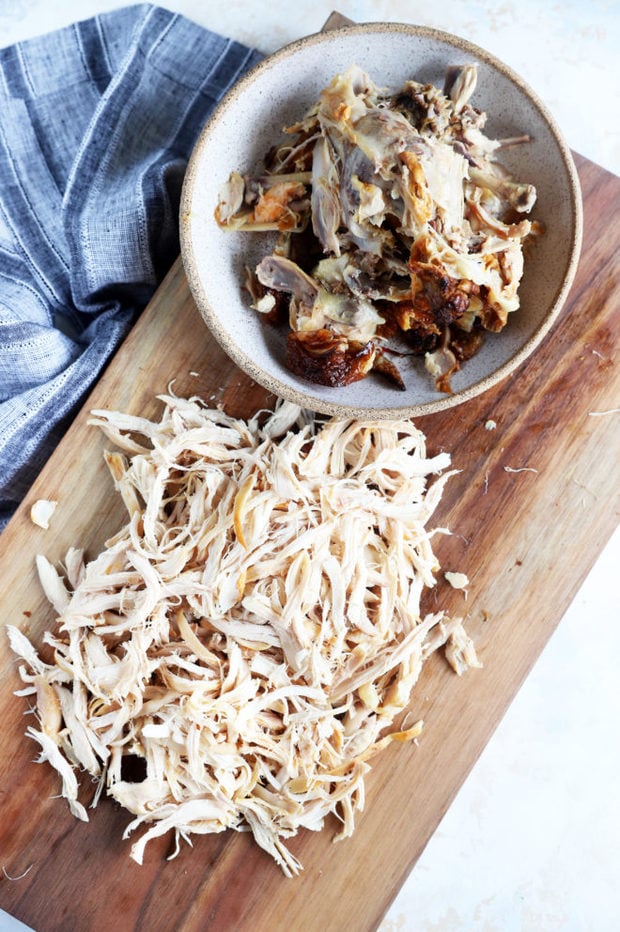 Overhead photo of shredded chicken and bones