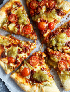 Slices of salsa verde chorizo pizza image