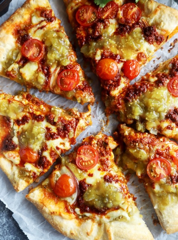 Slices of salsa verde chorizo pizza image