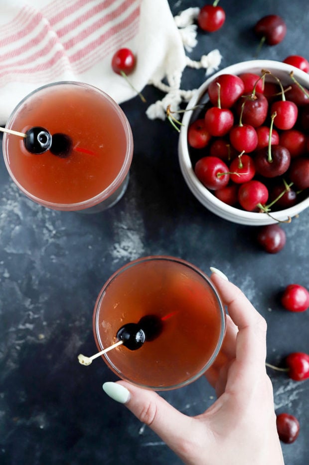 Hand holding cherry cocktail image