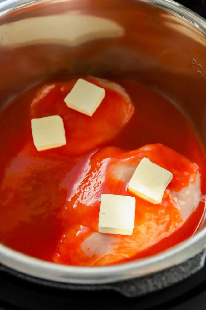 chicken in instant pot with buffalo sauce and butter