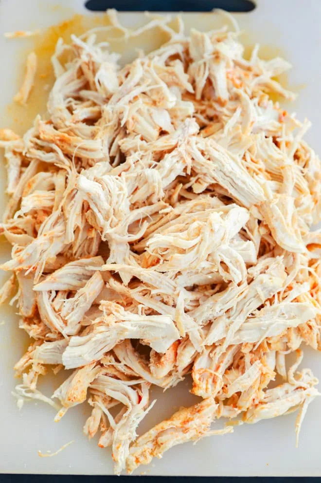 shredded chicken on a cutting board