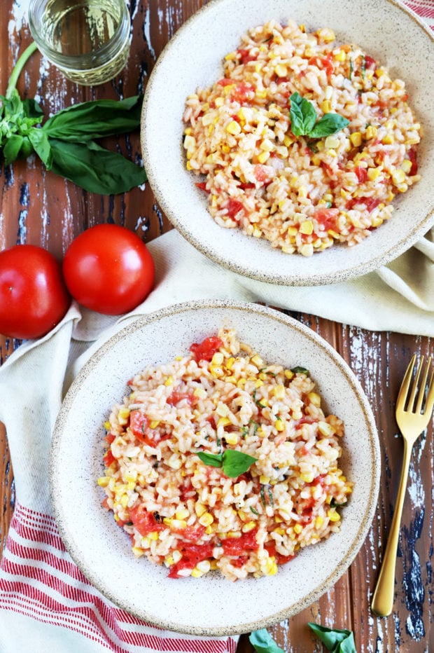 Summer tomato corn risotto in bowls with basil photo