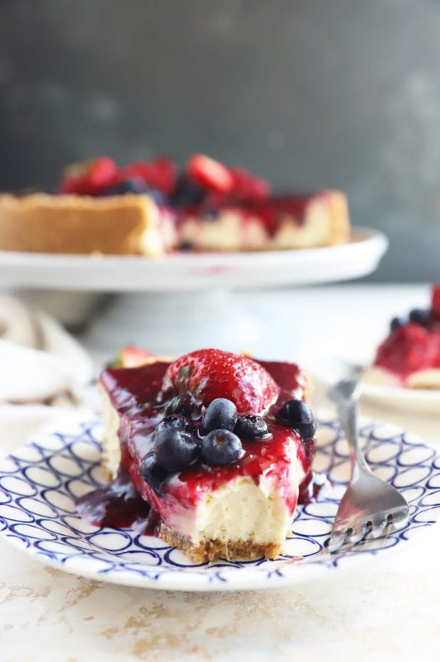 Slice of triple berry cheesecake image