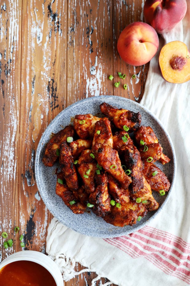 Peach bourbon chicken wings on a platter image