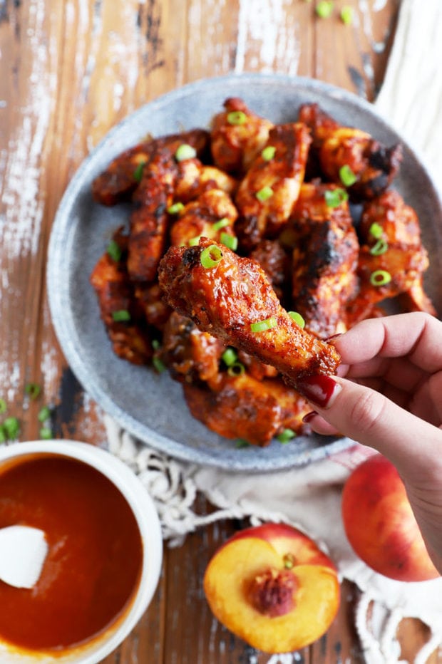 Hand holding bbq grilled wing picture labor day