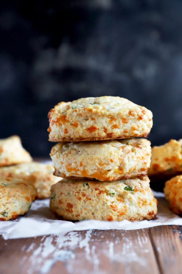 Side photo of a stack of cheddar biscuits