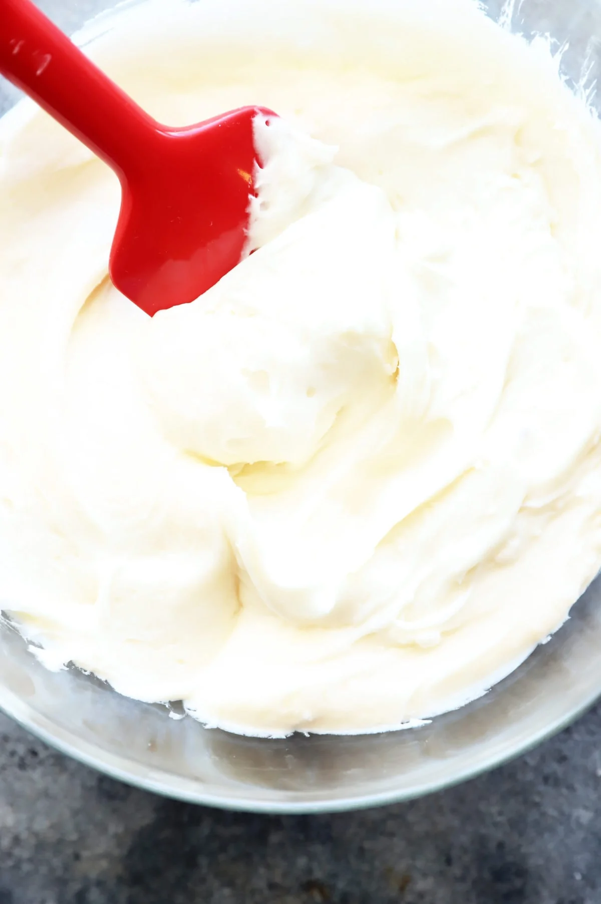 Cream cheese frosting in bowl with spatula image