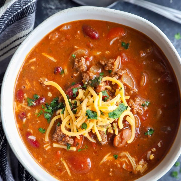 Overhead image of chili in a bowl with a spoon