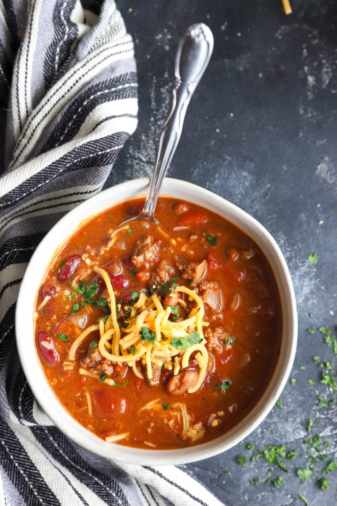 Overhead image of chili with chipotles and spoon