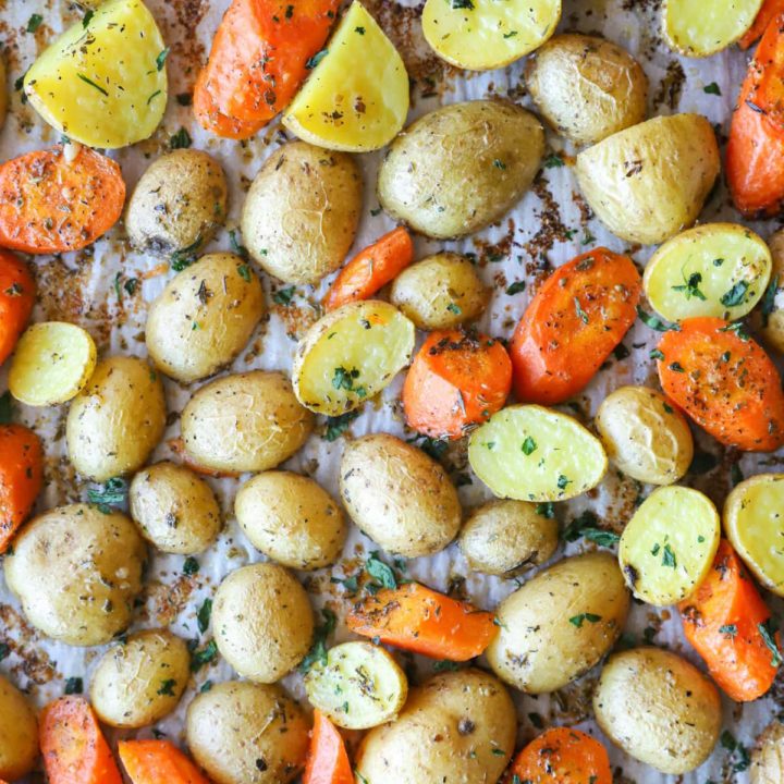 Overhead photo of potatoes and carrots on a sheet pan