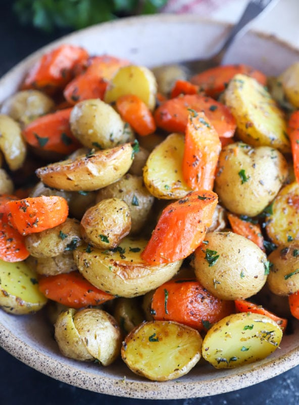 Garlic butter roasted carrots and potatoes in a bowl image